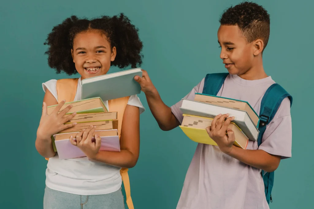 boy helping his friend with books
