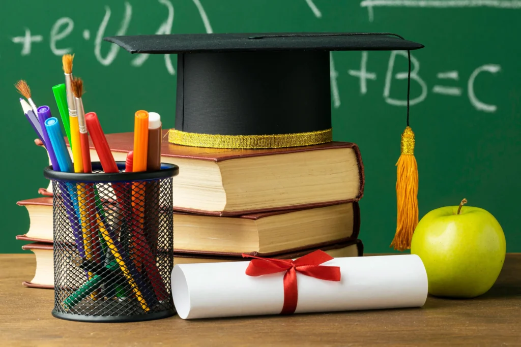 front view academic cap with books pencils min (1)